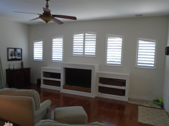 Five custom plantation shutters surrounding a fireplace in a Ponte Vedra home